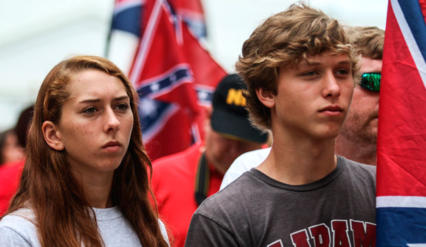 People listen to speakers on the steps of the Alabama state capitol building in Montgomery, Alabama, at a June 27, 2015 rally against the removal of the Confederate flag from a momument at the capital. (AP/Ron Harris)