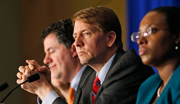 Consumer Financial Protection Bureau Director Richard Cordray, center, listens to comments during a panel discussion in Richmond, Virginia, March 26, 2015. (AP/Steve Helber)