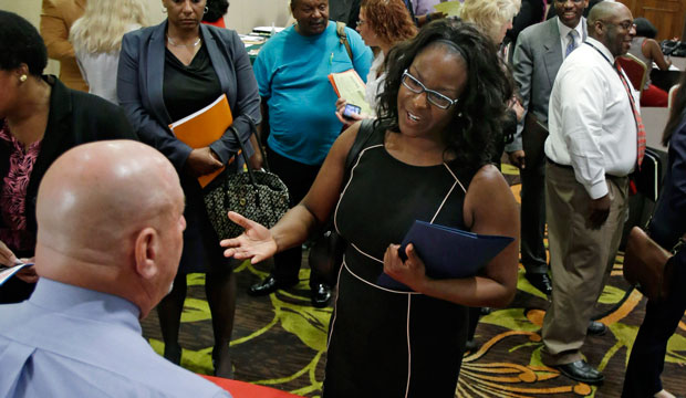 Marsha Lawson talks with a potential employer at the Cleveland Career Fair in Independence, Ohio, on June 12, 2014. (AP/Tony Dejak)