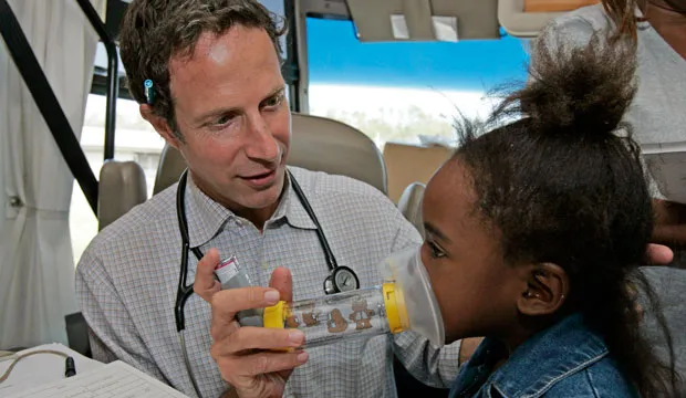 Dr. Alan Shapiro, of the Children's Health Fund in New York, gives an asthma breathing test to Ja'Shayna Davis in Gulfport, Mississippi, on September 13, 2005. (AP/Darron Cummings)