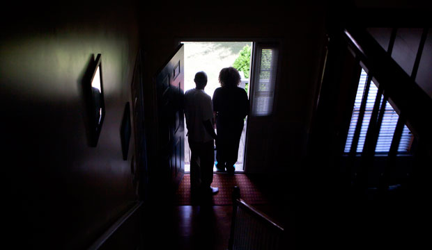 Michael and Patricia Jackson stand in the doorway of a home they are struggling to keep on June 16, 2012, in Marietta, Georgia. (AP/David Goldman)
