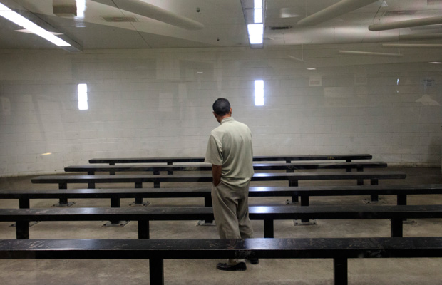 A man waits to be processed at a Border Patrol detention center in Imperial Beach, California, in January 2012. (AP/Gregory Bul)