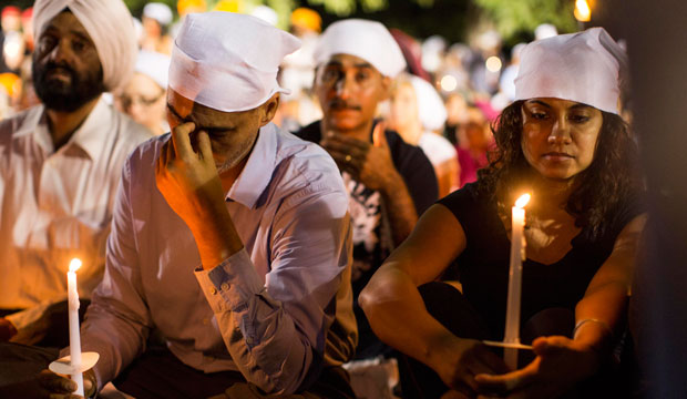 People attend a candlelight vigil for the victims of the mass shooting at the Sikh Temple of Wisconsin in Oak Creek. (AP/Tom Lynn)