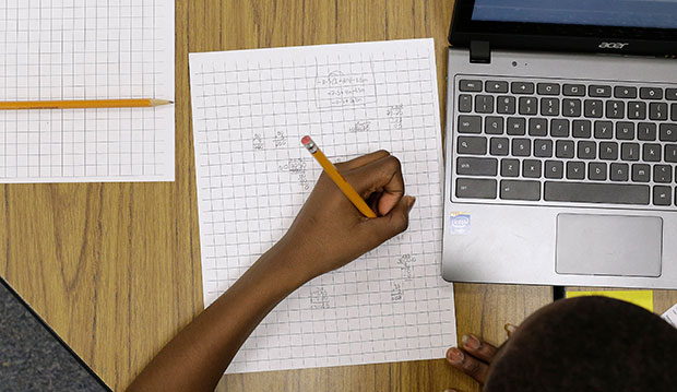 A 12-year-old student works on math problems as part of a trial run of a new state assessment test in Annapolis, Maryland, February 12, 2015. (AP/Patrick Semansky)