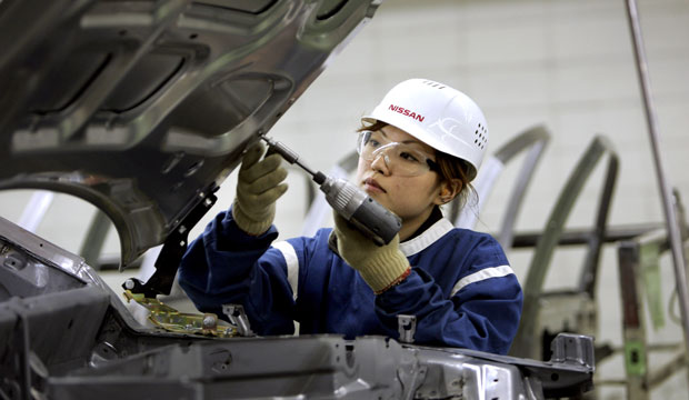 A worker screws a bolt into the hood at a car body manufacturing plant in Tochigi Prefecture, Japan, in 2007. (AP/Katsumi Kasahara)