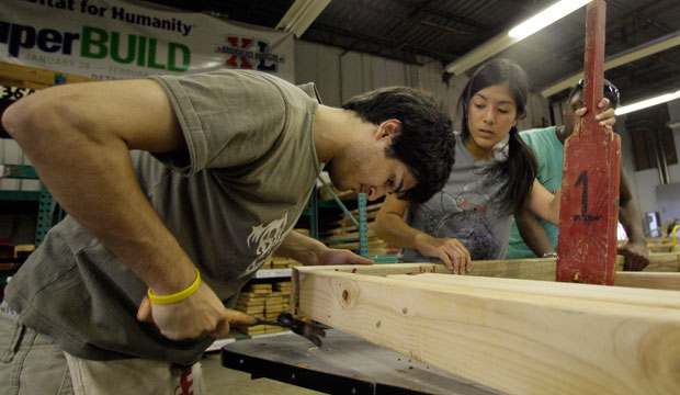 Rice University students work to assemble frames at the Habitat for Humanity warehouse in Houston, Texas, July 2009. (AP/David J. Phillip)