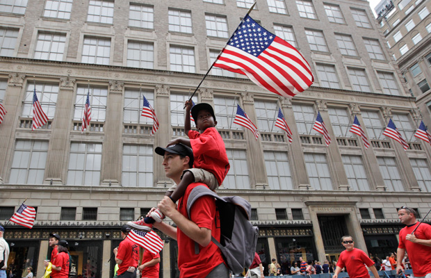 Duke Scoppa marches up Fifth Ave with his son during the Labor Parade, September 10, 2011, in New York. (AP/Mary Altaffer)