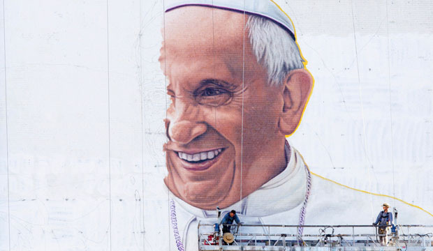 Painters work on a mural of Pope Francis on the side of a New York City building on August 28, 2015. (AP/Mark Lennihan)