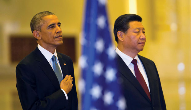 U.S. President Barack Obama stands with Chinese President Xi Jinping as the U.S. national anthem is played during a welcome ceremony in Beijing on November 12, 2014. (AP/Ng Han Guan)