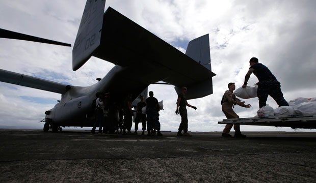 At Tacloban airport in the central Philippines, U.S. troops load relief supplies to a U.S. Marine MV-22 Osprey aircraft for airdrop to typhoon-ravaged remote places in 2013. (AP/Bullit Marquez)