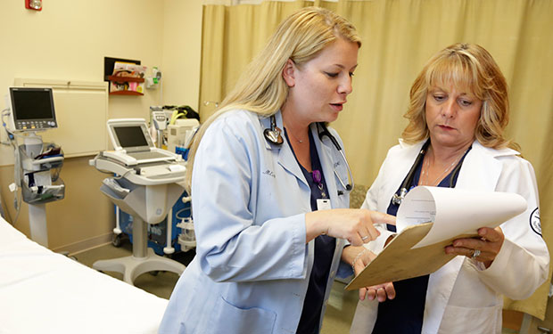 Nurse practitioners go over a patient's chart at Ingalls Family Care Center in Flossmoor, Illinois, June 2013. (AP/M. Spencer Green)