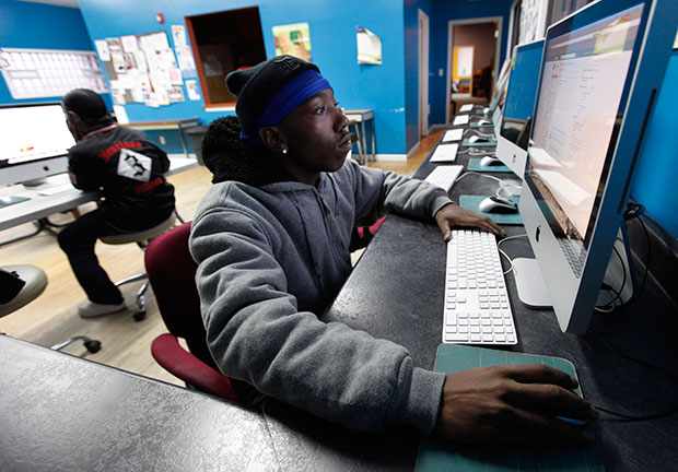 A young adult uses a computer at the Ruth Ellis Center, a drop-in shelter for LGBT youth in Detroit, March 2012. (AP/Paul Sancya)