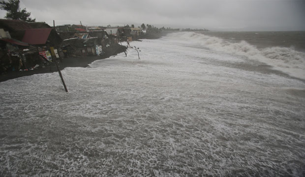 Strong waves threaten coastal houses as Typhoon Hagupit pounds Legazpi, Albay Province, in the eastern Philippines on December 7, 2014. (AP/Aaron Favila)