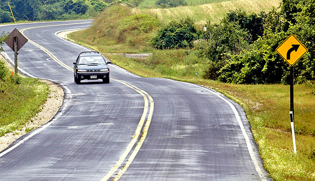 A car drives along County Highway A near Elkhart Lake, Wisconsin, July 2004. (AP Photo/Morry Gash)