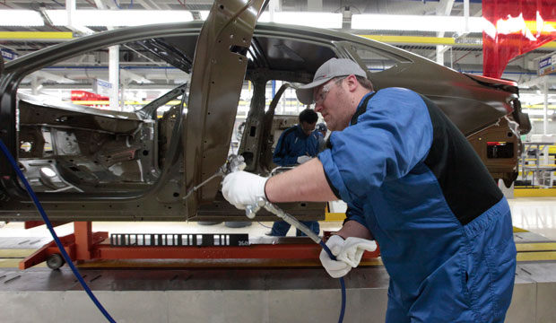 An assembly line employee works on a car in Sterling Heights, Michigan, on March 14, 2014. (AP/Paul Sancya)