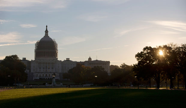 The sun rises behind the U.S. Capitol grounds in Washington, D.C., October 2014. (AP/Carolyn Kaster)