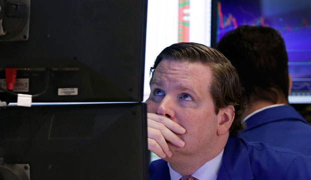 Specialist Gregg Maloney works at his post on the floor of the New York Stock Exchange on October 13, 2015. (AP/Richard Drew)
