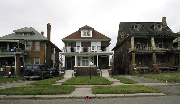 Pictured is a street scene in Detroit, where it’s not uncommon to find dilapidated homes side by side with occupied homes, December 2014. (AP/Beth J. Harpaz)