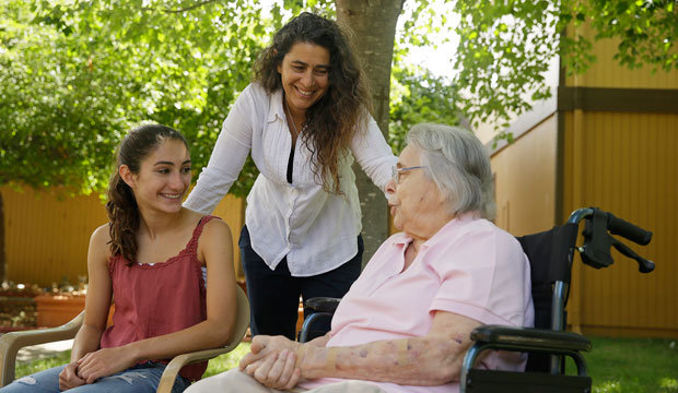 Kamila Al-Najjar, center, visits with her mother, Joan Groen, right, along with her daughter, Inanna Al-Najjar, left, at an assisted living facility in Santa Rosa, California, on July 6, 2015. (AP/Eric Risberg)