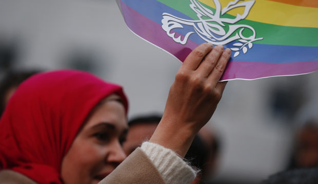 A Muslim woman holds up a peace flag in Milan, Italy, during a protest against violence on November 21, 2015. (AP/Luca Bruno)