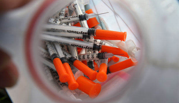 A jug of used needles to exchange for new is seen near in an industrial area of Camden, New Jersey. (AP/Mel Evans)