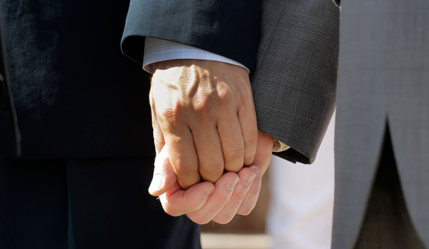 Vic Holmes, left, and partner Mark Phariss, right, hold hands on the steps of the Texas Capitol during a news conference celebrating marriage equality on June 29, 2015, in Austin, Texas. (AP/Eric Gay)