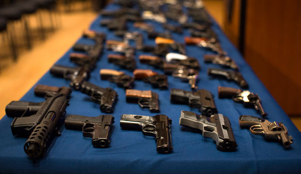Nearly 100 confiscated illegal firearms—many from out-of-state sources, notably South Carolina—rest on a table before a press conference on October 12, 2012, in New York City. (AP/John Minchillo)