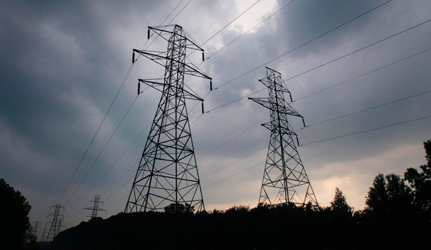 Power transmission lines stand against a sky of gathering storm clouds in Lansing, Michigan, on August 21, 2003. (AP/Al Goldis)