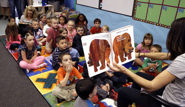 Kindergarten students listen as teacher Amy Holland reads at Nancy Ryles Elementary School in Beaverton, Oregon, on September 8, 2015. (AP/Don Ryan)