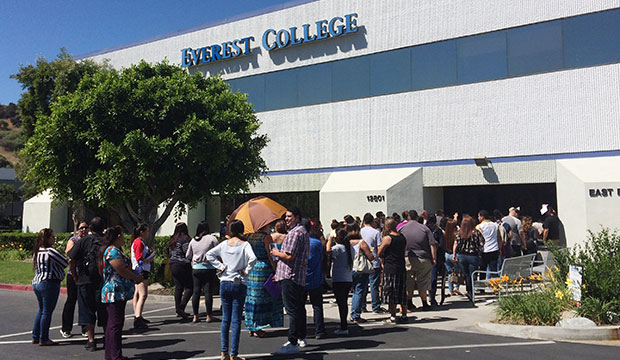 Students wait outside Everest College in Industry, California, hoping to get their transcriptions and information on loan forgiveness and transferring credits to other schools, April 28, 2015, following the collapse of Corinthian Colleges. (AP/Christine Armario)