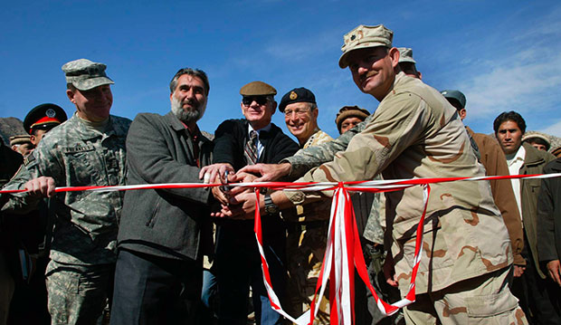 U.S. Ambassador to Afghanistan Robert Neumann, center, Nuristan Gov. Tamim Nuristani, left, and NATO Commander in Afghanistan British Gen. David Richards cut a ribbon opening a Provincial Reconstruction Team in Nuristan, Afghanistan, in 2006. (AP)