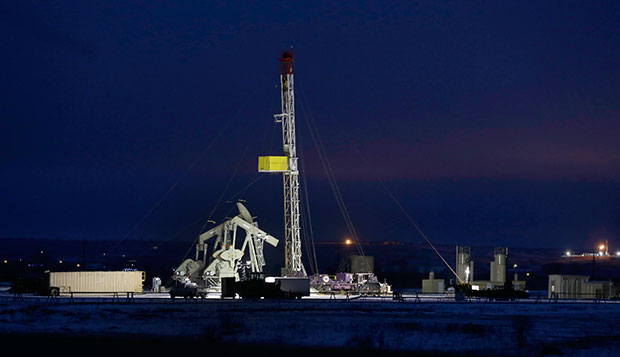 Lights shine on oil drilling activities, December 15, 2014, near Williston, North Dakota. (AP/Eric Gay)
