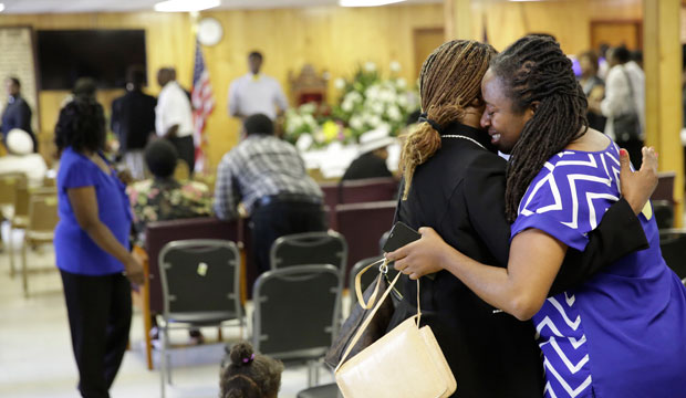 Rev. Waltrina Middleton, one of this year's faith leaders to watch, embraces a member of the Emanuel African Methodist Episcopal Church in Charleston, South Carolina, on  June 21, 2015. (AP/David Goldman)