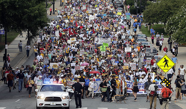 Demonstrators march through the streets of Winston-Salem, North Carolina, July 13, 2015, after the beginning of a federal voting rights trial challenging a 2013 state law. (AP/Chuck Burton)