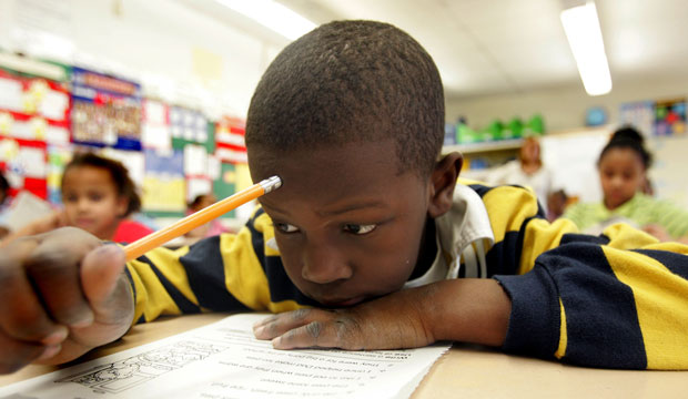 A second-grade student reads a book during a literacy class at the John Fenwick Elementary School in Salem, New Jersey, February 2006. (AP/Jose F. Moreno)