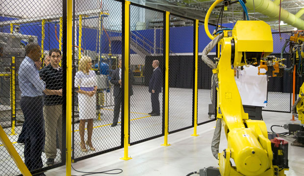 President Barack Obama, accompanied by Jill Biden, speaks with student-apprentice Phillip Gates, second from left, at the Michigan Technical Education Center at Macomb Community College in Warren, Michigan, on September 9, 2015. (AP/Andrew Harnik)