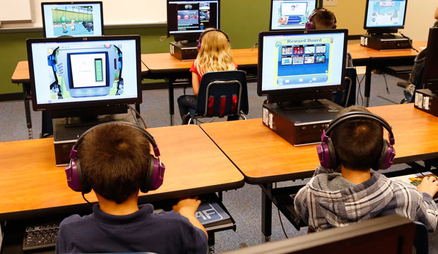 In this July 21, 2014 photo, students at Buchanan Elementary School work in the computer lab at the school in Oklahoma City. (AP/Sue Ogrocki)
