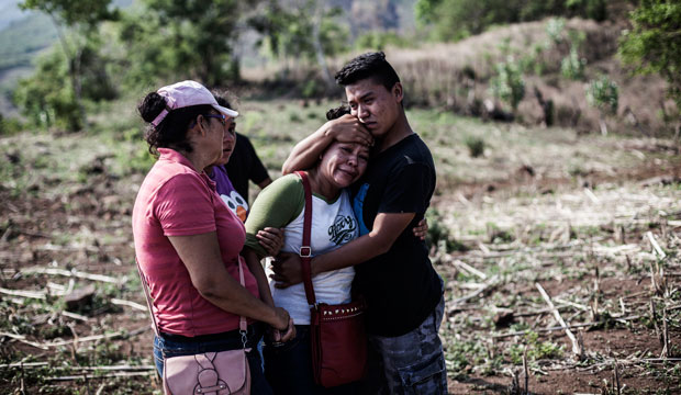 The son of Alberto Hernandez—a man who was kidnapped and murdered by gang members—embraces his mother in a rural area near Caserío el Chumpe, El Salvador, June 2015. (AP/Manu Brabo)
