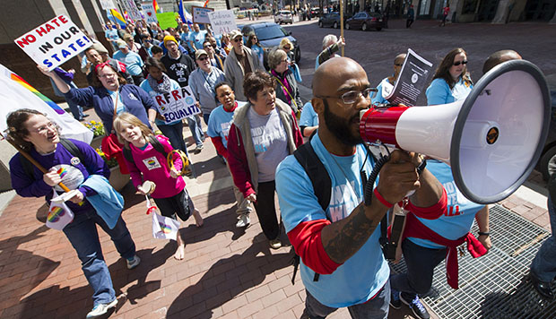 Dominic Dorsey uses a megaphone as he leads a group of opponents to Indiana S.B. 101, the state's Religious Freedom Restoration Act, in a march toward Lucas Oil Stadium in Indianapolis, April 4, 2015. (AP/Doug McSchooler)