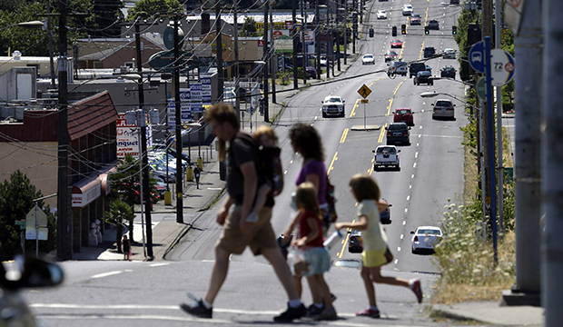 Pedestrians cross the wide swath of 82nd Avenue in East Portland, Oregon, July 2015. (AP/Don Ryan)