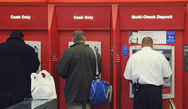 Customers use ATMs at a bank branch office, October 2009. (AP/Lisa Poole)