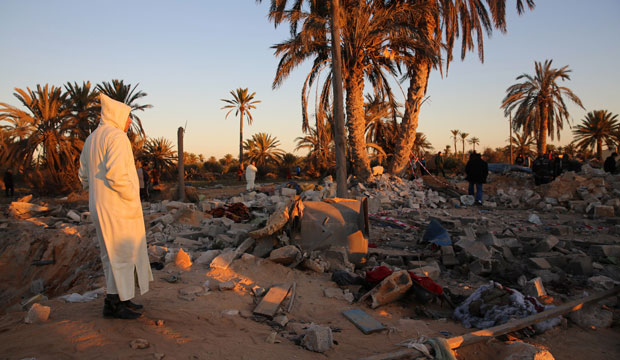 People gather after an airstrike on a house and training camp belonging to ISIS, west of Sabratha, Libya, February 19, 2016. (AP/Mohamed Ben Khalifa)