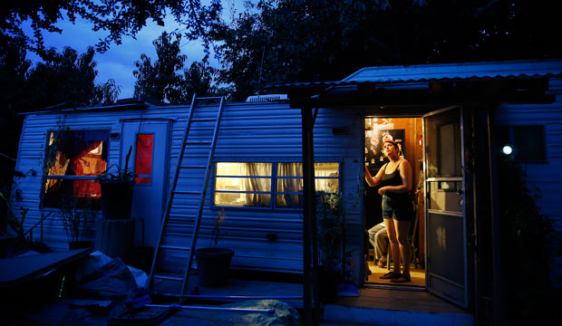 A teenage girl stands at the door of her family's home near Fresno, California, on September 14, 2015. (AP/John Locher)