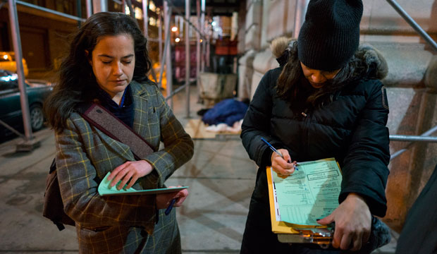 Alexis Sypek, left, and Victoria Parker conduct a survey of homeless people on the streets of New York City on February 9, 2016. (AP/Craig Ruttle)