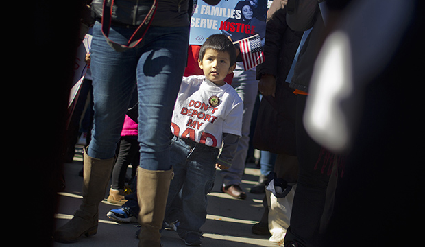 A 2-year-old watches his parents take part in a rally for immigration reform at the Supreme Court in Washington, November 20, 2015, on the one-year anniversary of President Barack Obama's announcement concerning DAPA. (AP/Pablo Martinez Monsivais)