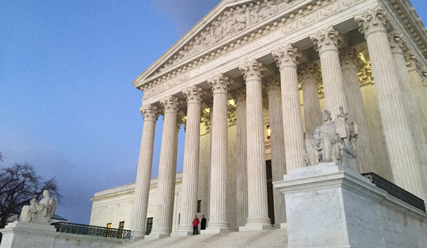 People stand on the steps of the U.S. Supreme Court on February 13, 2016, in Washington, D.C. (AP/Jon Elswick)