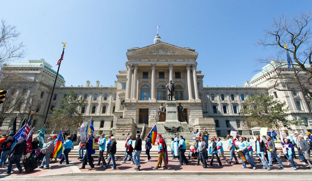 Opponents of Indiana's Religious Freedom Restoration Act march in protest past the Indiana Statehouse on April 4, 2015. (AP/Doug McSchooler)