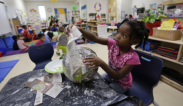 A pre-K student does paper-mache at the South Education Center in San Antonio, April 2014. (AP/Eric Gay)