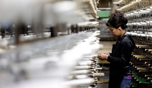 Juthathip Ruiz works among racks of yarn on November 23, 2015, at a factory in Pennsylvania. (AP/Matt Rourke)