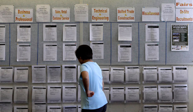 A woman looks at listings on a bulletin board in Westminster, California, on September 8, 2011. (AP/Jae C. Hong)